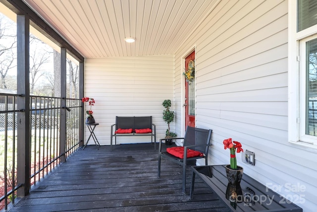 wooden terrace featuring covered porch