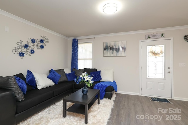 living area with ornamental molding, baseboards, and wood finished floors