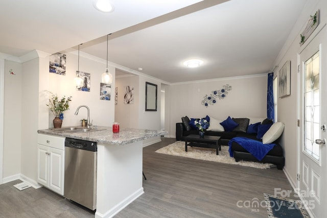 kitchen with open floor plan, white cabinets, a sink, dishwasher, and a kitchen breakfast bar