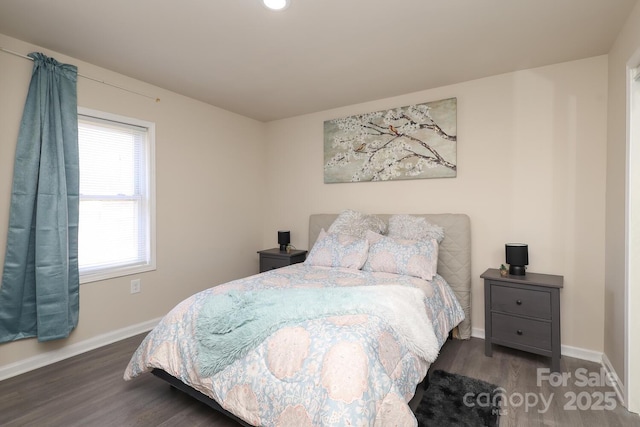 bedroom featuring dark wood-style floors and baseboards