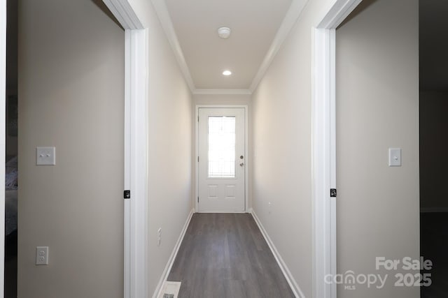 doorway to outside featuring baseboards, recessed lighting, dark wood-style floors, and crown molding