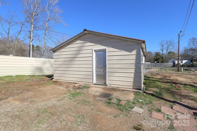 view of outbuilding with fence and an outdoor structure