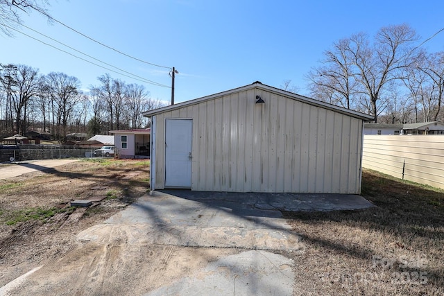 view of outbuilding with fence