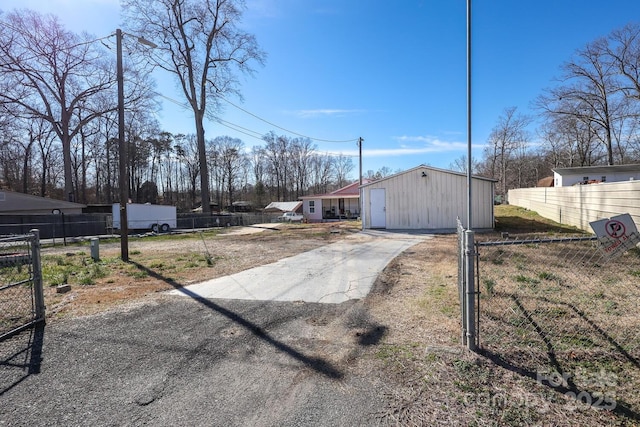 view of yard featuring driveway and fence