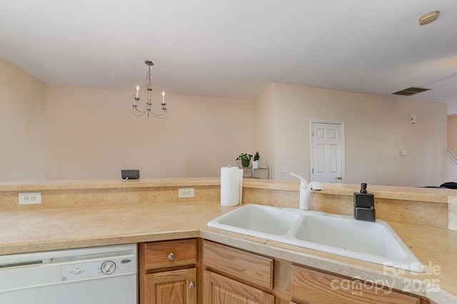 kitchen featuring sink, white dishwasher, a chandelier, and decorative light fixtures