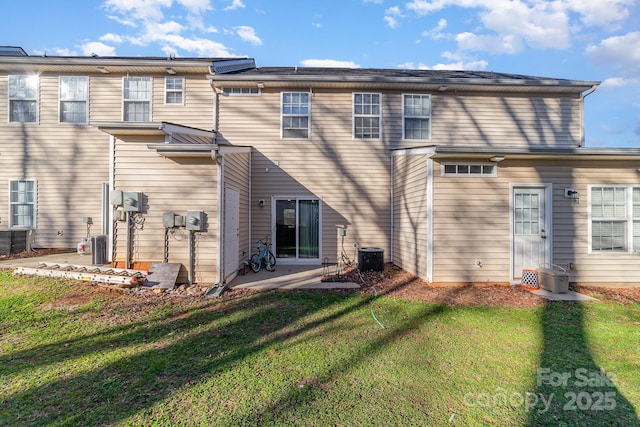 back of property featuring a patio, a lawn, and central air condition unit