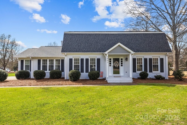 dutch colonial with brick siding, a shingled roof, and a front yard