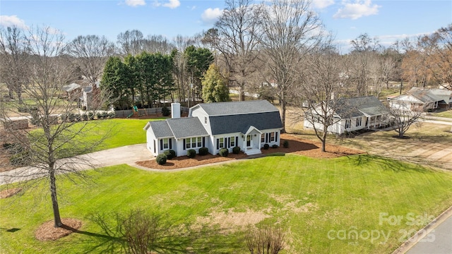 view of front of house with a shingled roof, a gambrel roof, a front yard, fence, and driveway