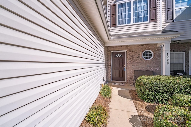 property entrance featuring brick siding