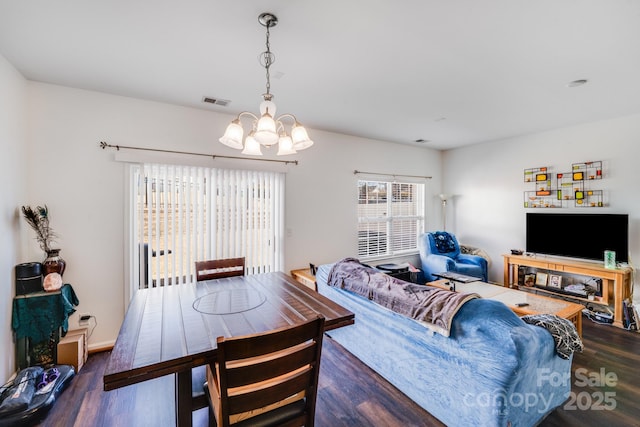 dining area featuring a notable chandelier, dark wood finished floors, and visible vents