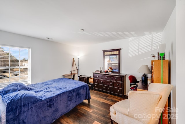 bedroom featuring visible vents and dark wood-type flooring