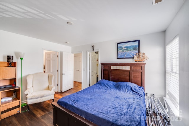 bedroom with visible vents and dark wood-style flooring