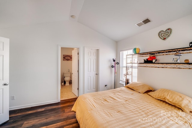 bedroom with dark wood-style flooring, lofted ceiling, visible vents, ensuite bath, and baseboards