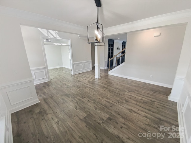 unfurnished dining area featuring crown molding and dark hardwood / wood-style floors