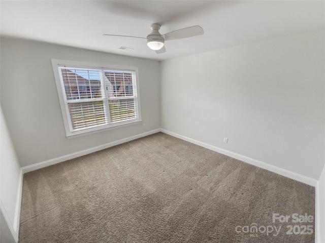 carpeted empty room featuring ceiling fan