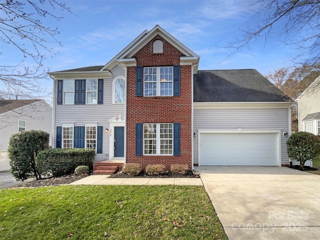 view of front of house featuring a front lawn, brick siding, driveway, and an attached garage