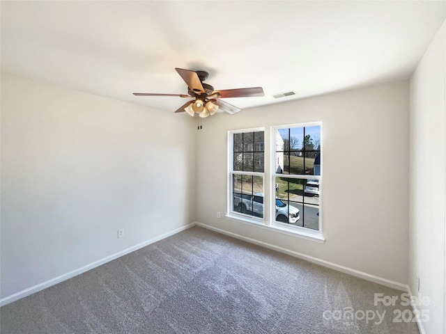 carpeted spare room with ceiling fan