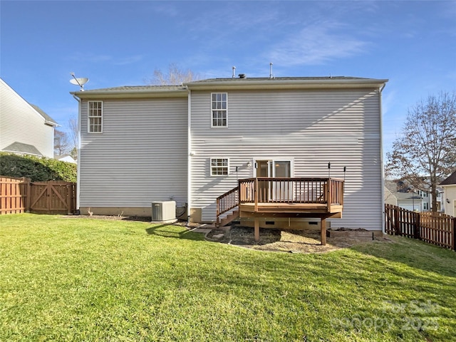 back of house with central air condition unit, a wooden deck, and a lawn