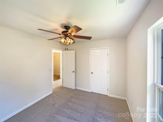 unfurnished bedroom featuring ceiling fan and light carpet