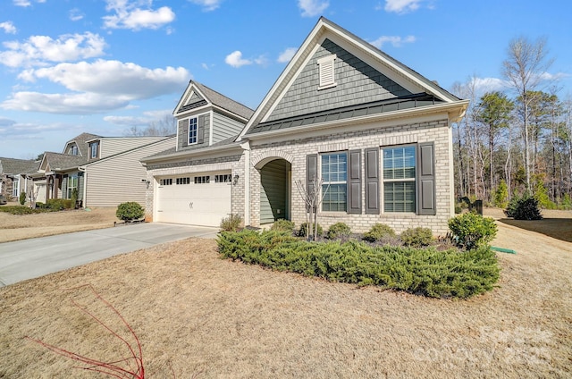 view of front of house featuring a garage, concrete driveway, metal roof, a standing seam roof, and brick siding