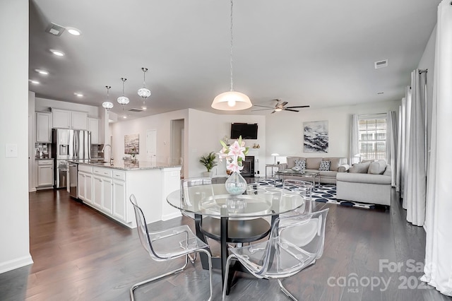 dining room featuring a ceiling fan, recessed lighting, visible vents, and dark wood finished floors