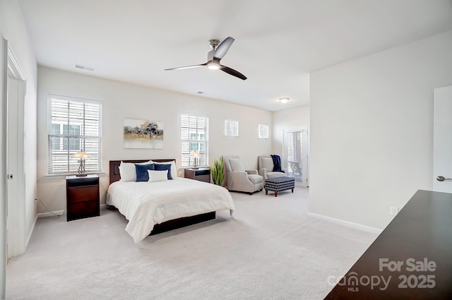 bedroom featuring light carpet, multiple windows, visible vents, and baseboards