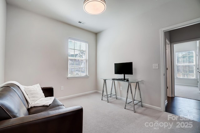 interior space featuring baseboards, carpet, visible vents, and attic access