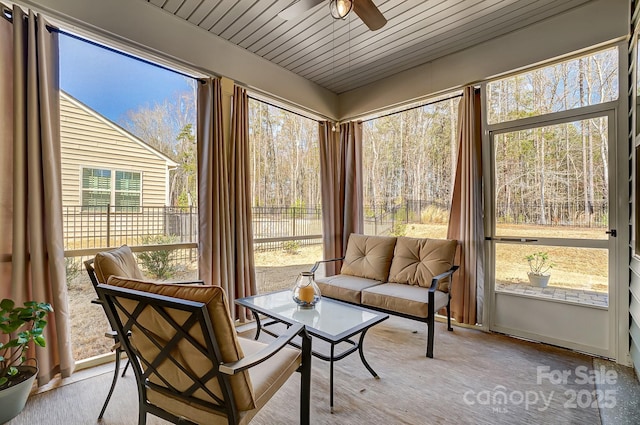 sunroom / solarium with wooden ceiling and a ceiling fan