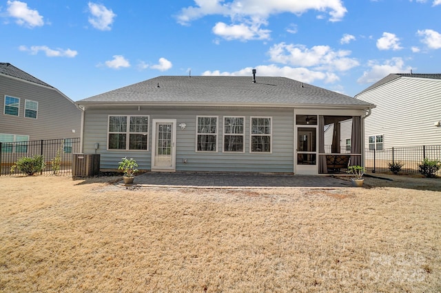 rear view of property with a sunroom, fence, a lawn, and roof with shingles