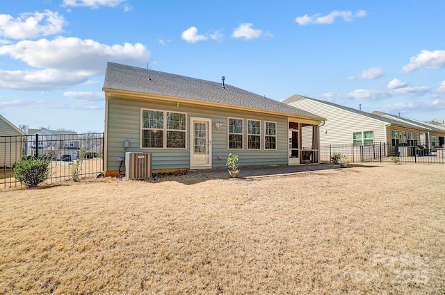 back of house with a patio area, fence, central AC unit, and roof with shingles