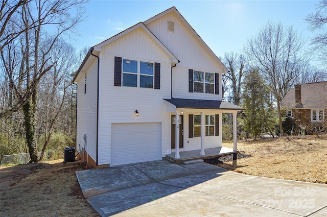 view of front of house featuring a garage, driveway, a porch, and cooling unit