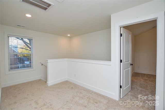 carpeted spare room with baseboards, visible vents, and recessed lighting