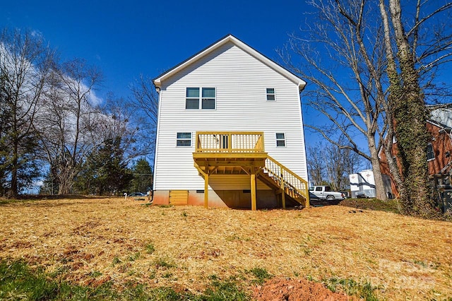 rear view of property featuring crawl space, stairs, and a deck