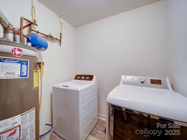 3841 Shasta Cir, Clover, SC 29710 - laundry area featuring gas water heater, washer and clothes dryer, light wood-style flooring, and a textured ceiling