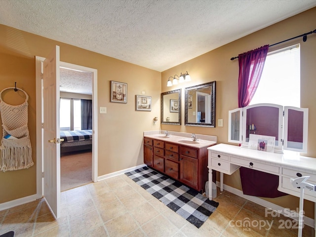 3841 Shasta Cir, Clover, SC 29710 - bathroom with baseboards, a textured ceiling, double vanity, and ensuite bathroom