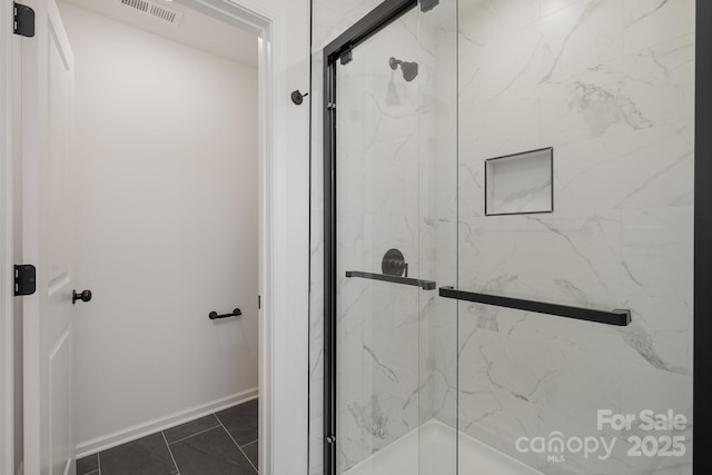 full bath with a stall shower, visible vents, and baseboards