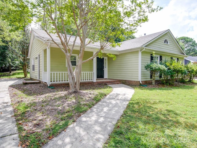 single story home featuring a front yard and covered porch