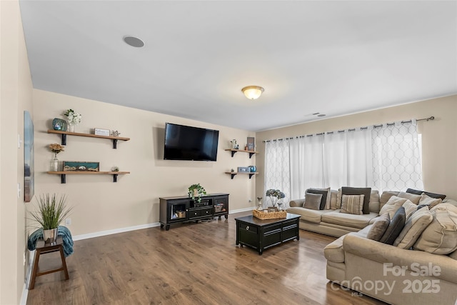 living room featuring dark wood finished floors and baseboards