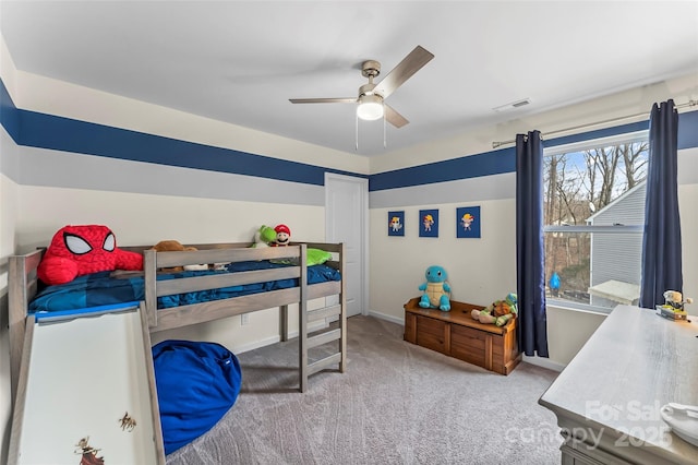 bedroom with ceiling fan, visible vents, baseboards, and light colored carpet