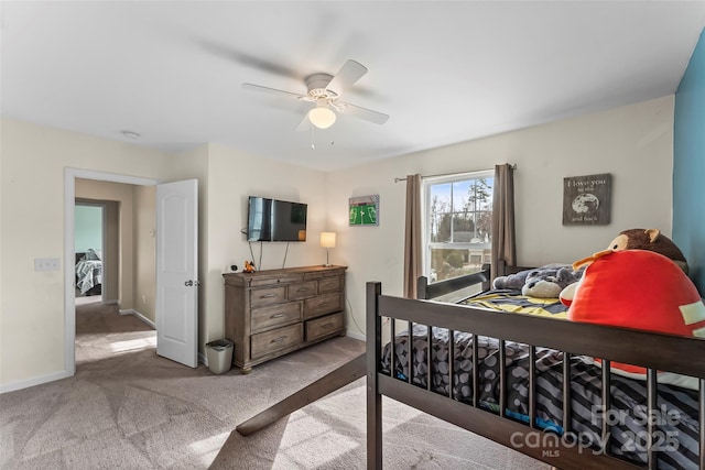 carpeted bedroom featuring ceiling fan and baseboards