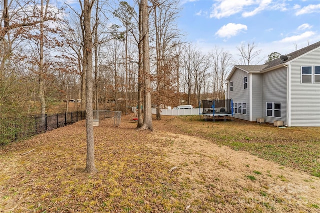 view of yard with a fenced backyard and a trampoline