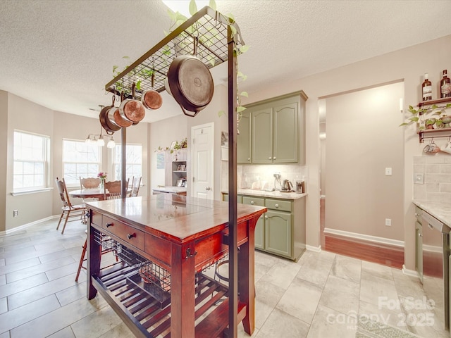 dining area featuring a textured ceiling, light tile patterned floors, a chandelier, and baseboards