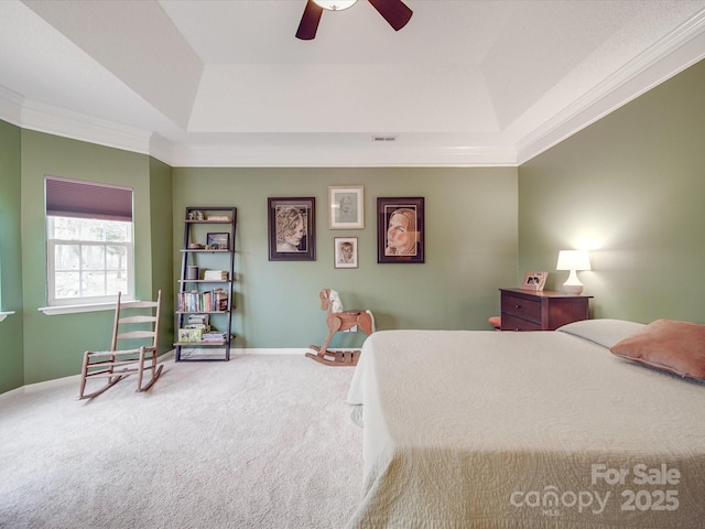 carpeted bedroom featuring crown molding, a raised ceiling, visible vents, ceiling fan, and baseboards