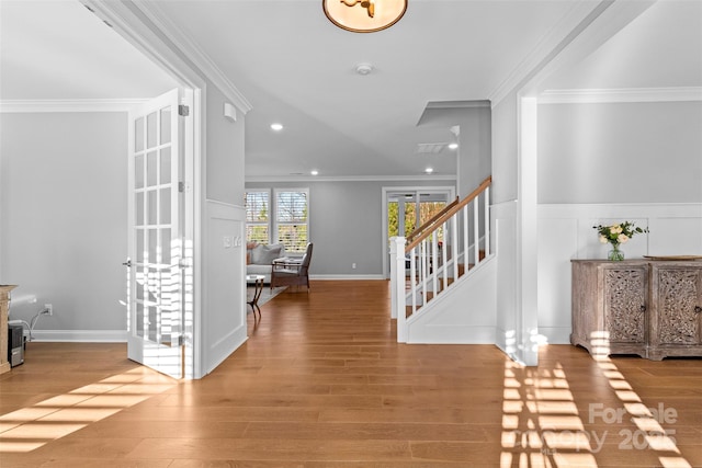 entryway featuring stairs, ornamental molding, light wood-type flooring, and recessed lighting