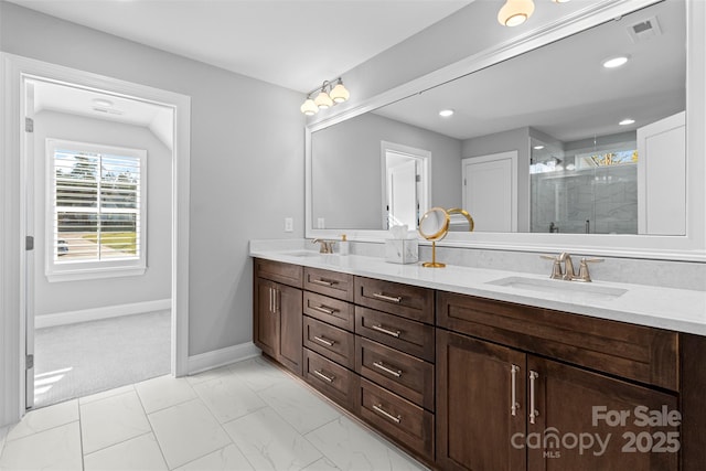 full bathroom with double vanity, a shower stall, visible vents, and a sink