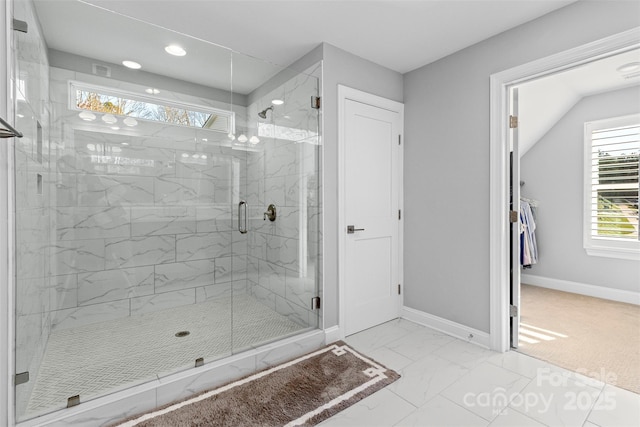 bathroom with marble finish floor, a marble finish shower, and baseboards