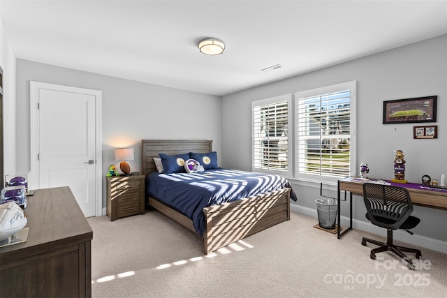 carpeted bedroom with visible vents and baseboards