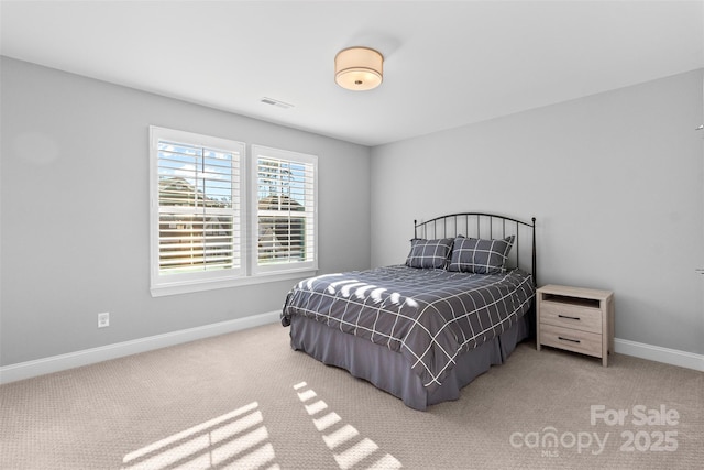 bedroom with carpet floors, baseboards, and visible vents