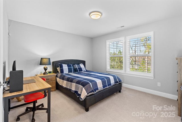 carpeted bedroom featuring baseboards and visible vents