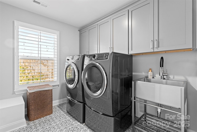 laundry room with cabinet space, baseboards, visible vents, and washer and dryer